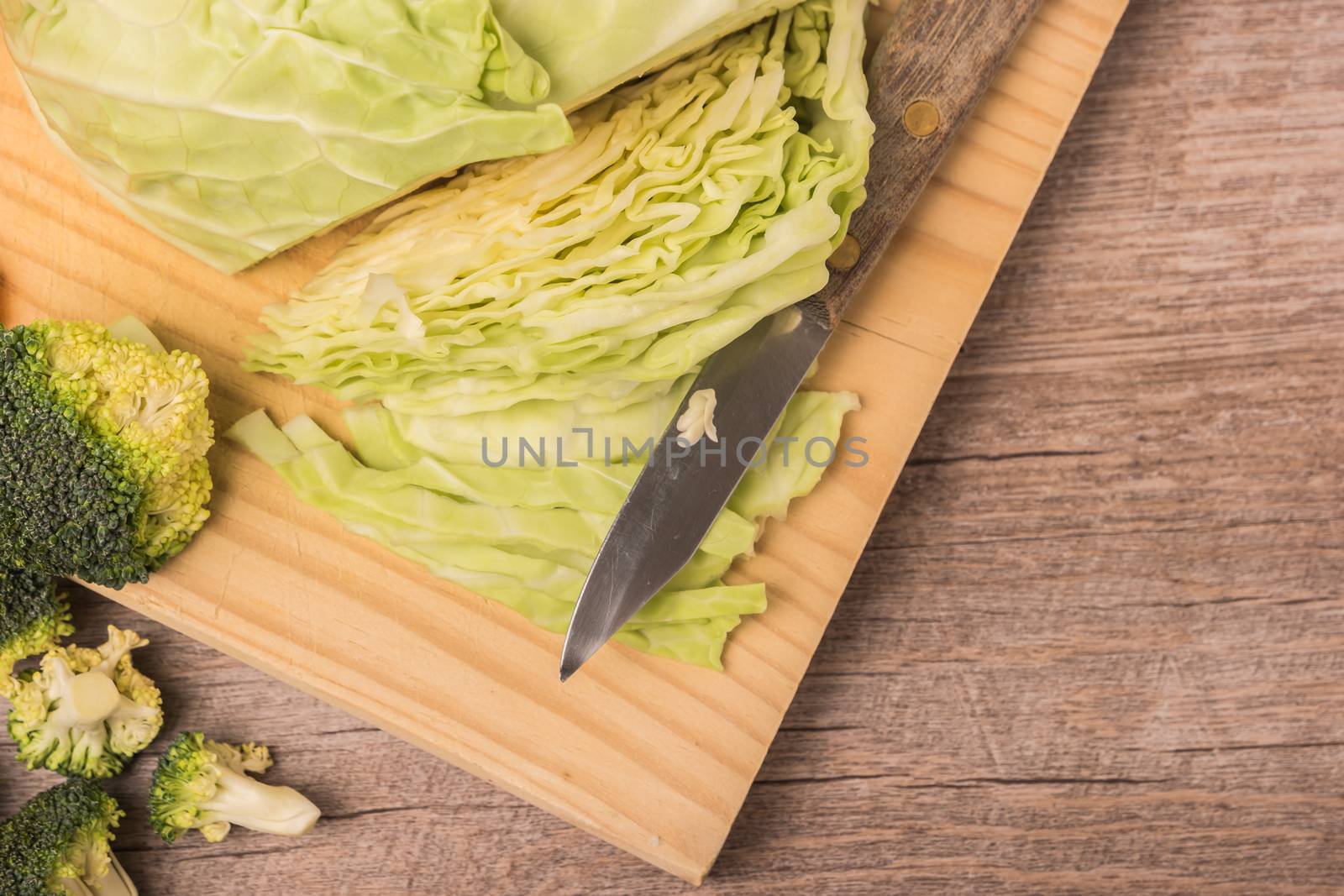 Fresh vegetables from the garden, cabbage and broccoli on a wooden table by AnaMarques