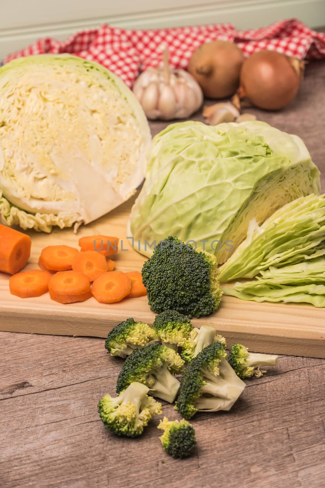 Fresh vegetables from the garden, cabbage and broccoli on a wooden table by AnaMarques