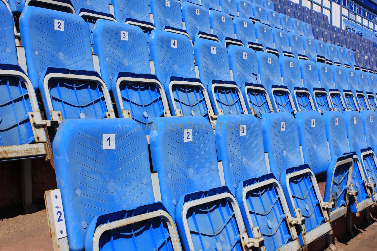 Tribune with folding chairs at small old stadium