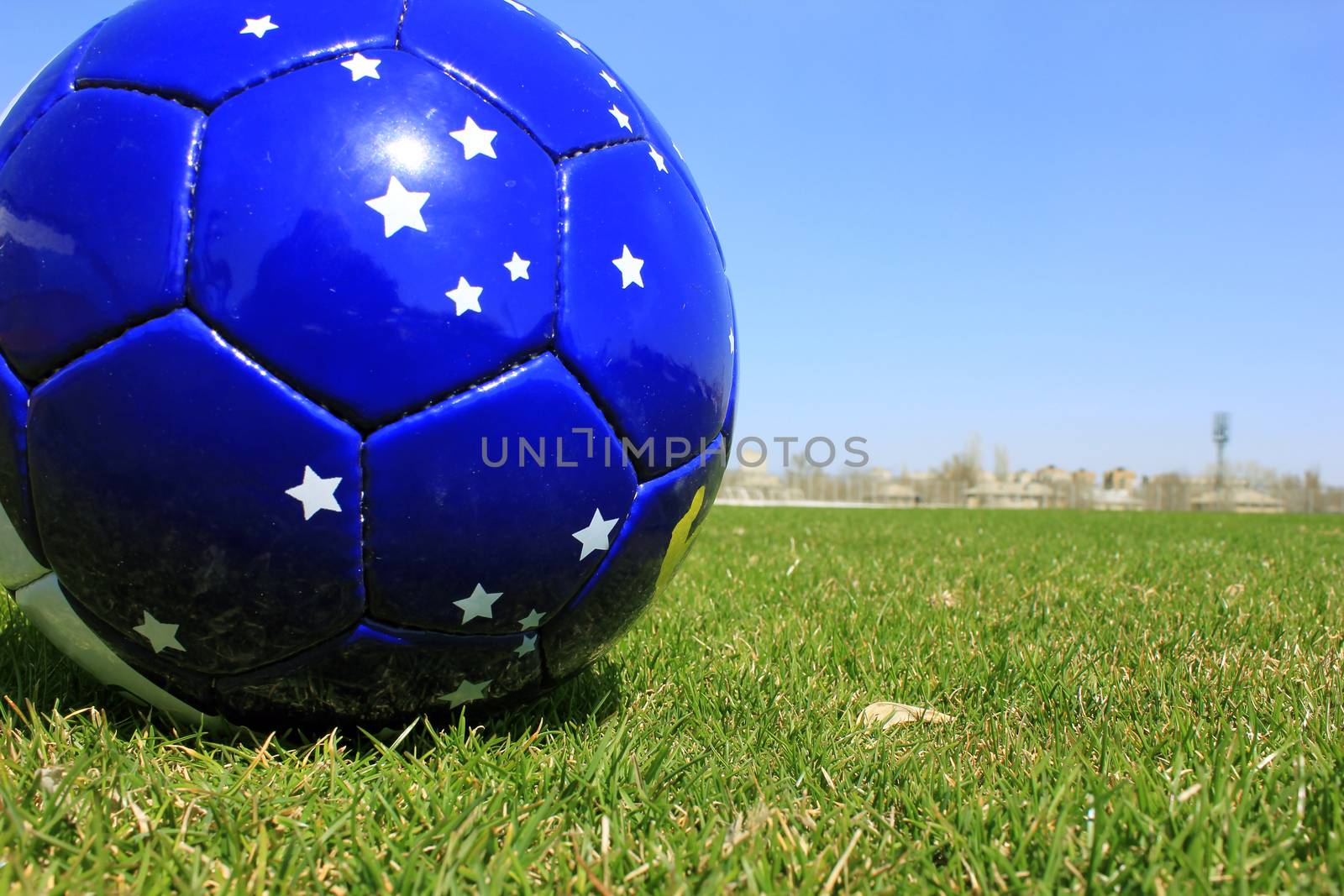 Football on a grass lawn of sports stadium