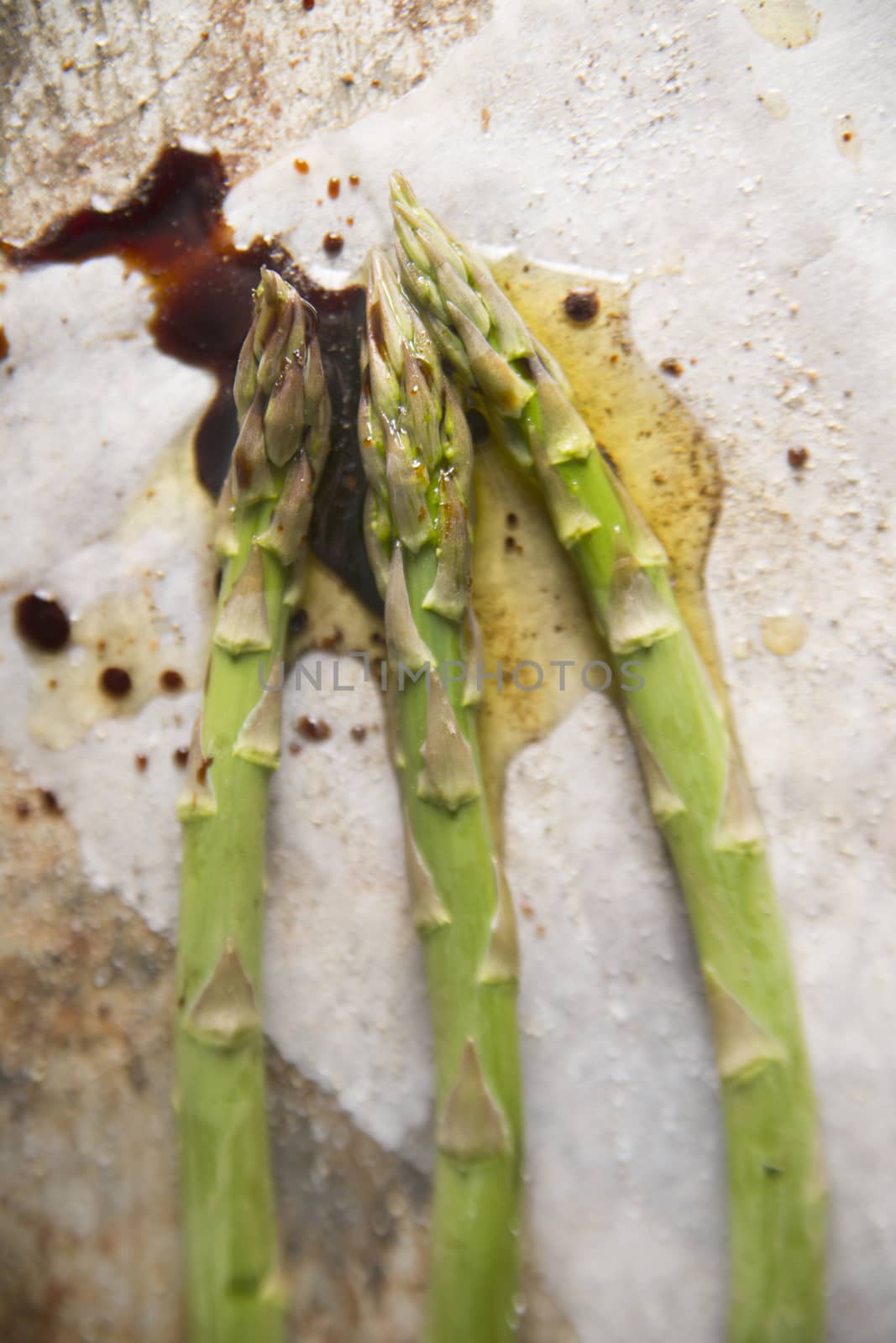 Presentation of some raw asparagus on metal background