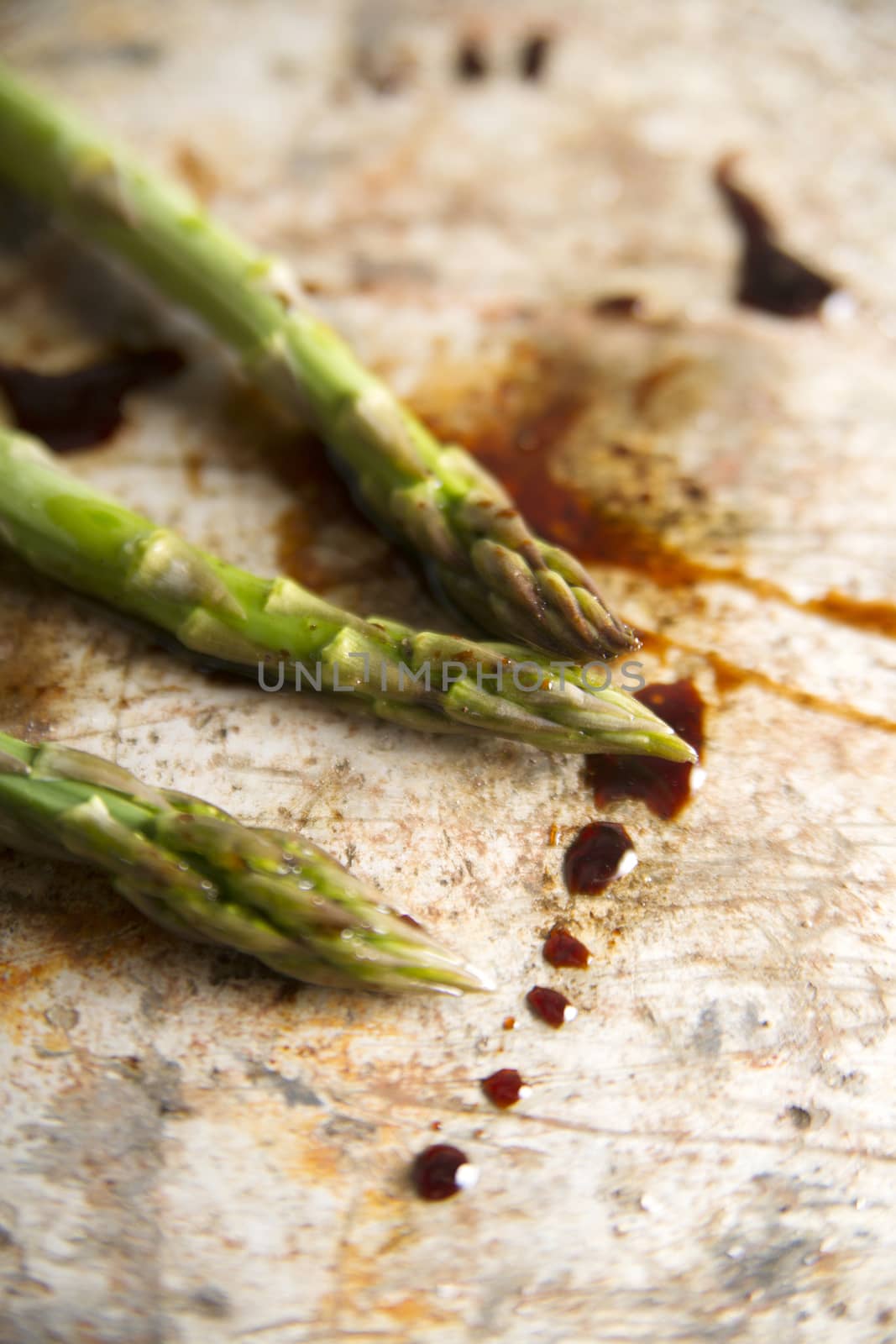 Presentation of some raw asparagus on metal background