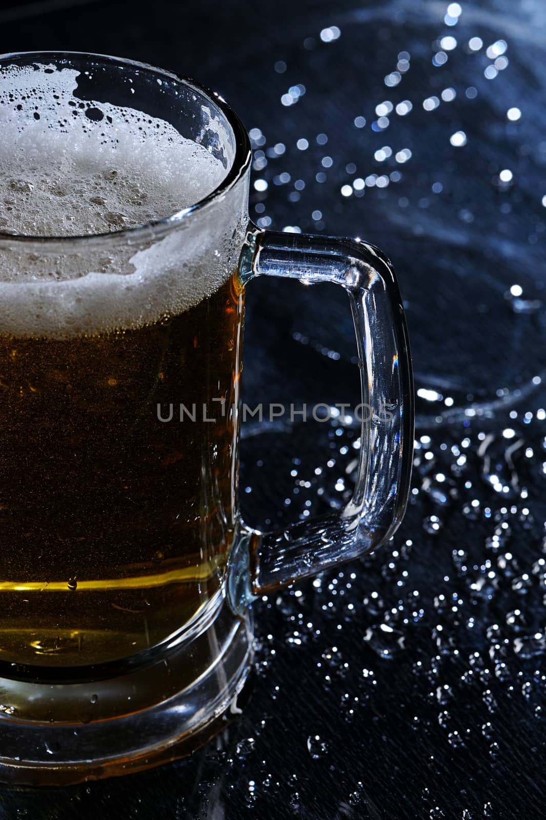 Glass with Beer on blured black background