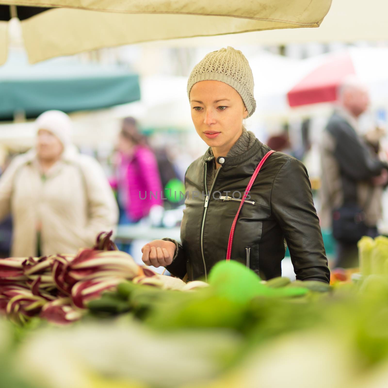 Woman buying vegetable at local food market.  by kasto