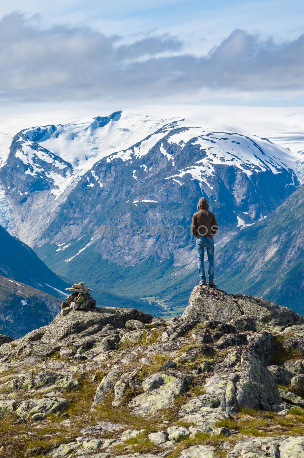 Man on top of mountain in Norway by alexpolo