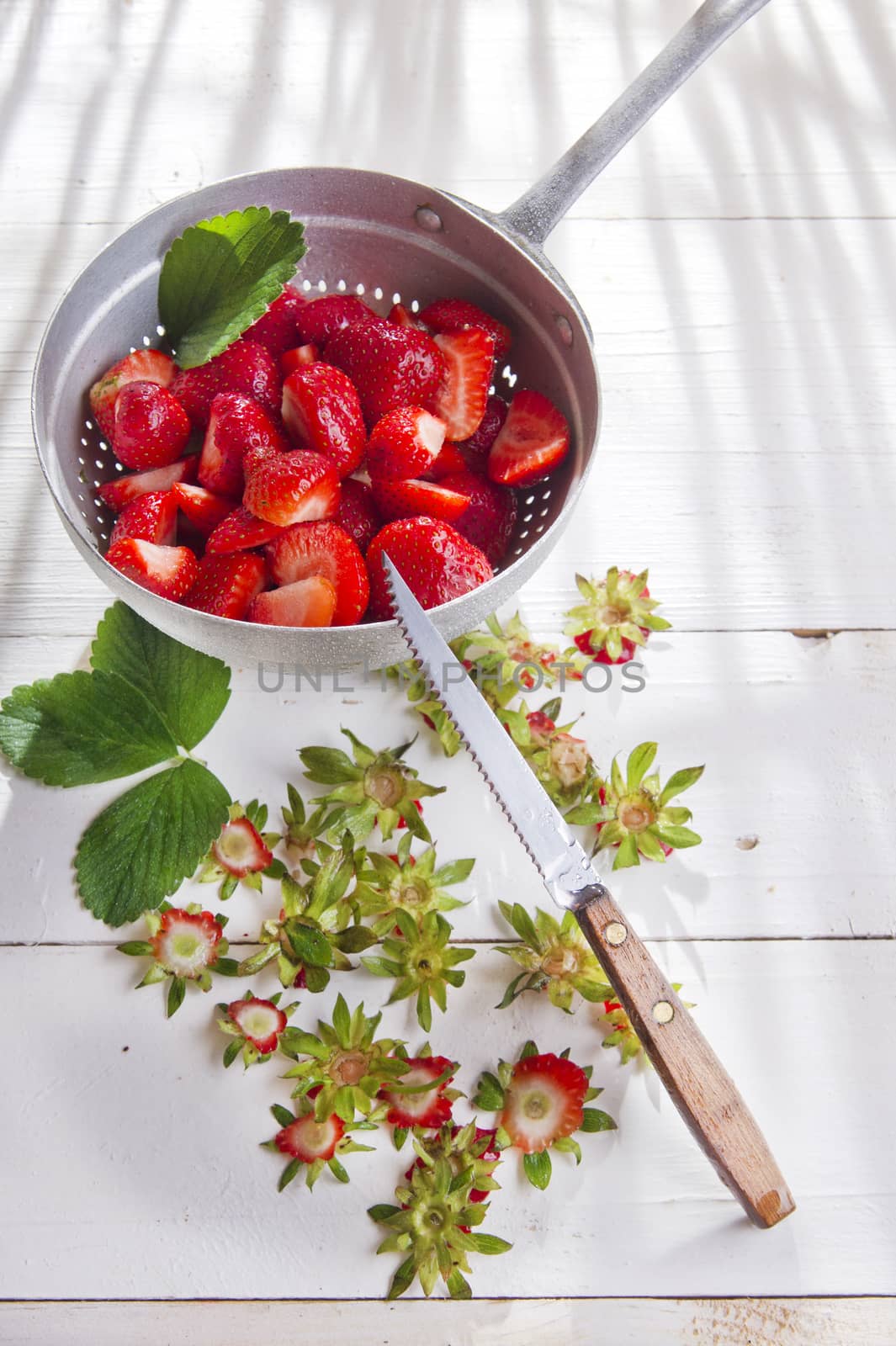 Strawberries into small pieces  by fotografiche.eu