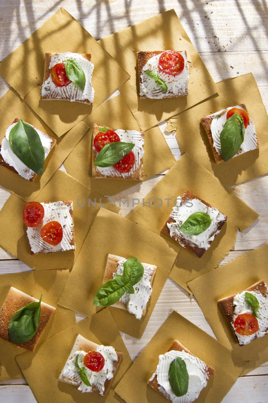 Tricolor cocktail canapes, cheese and tomato salad 