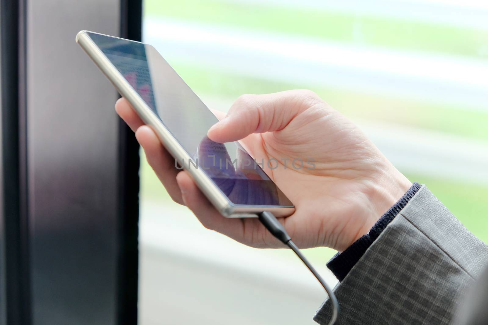 Close up image of businessman hand text messaging on his phone