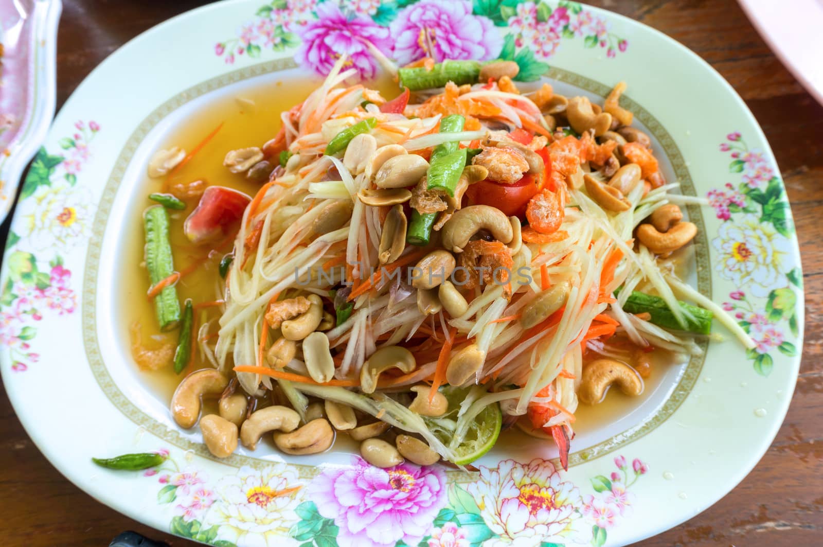 Papaya salad, Thai food in Plate on Wood Table