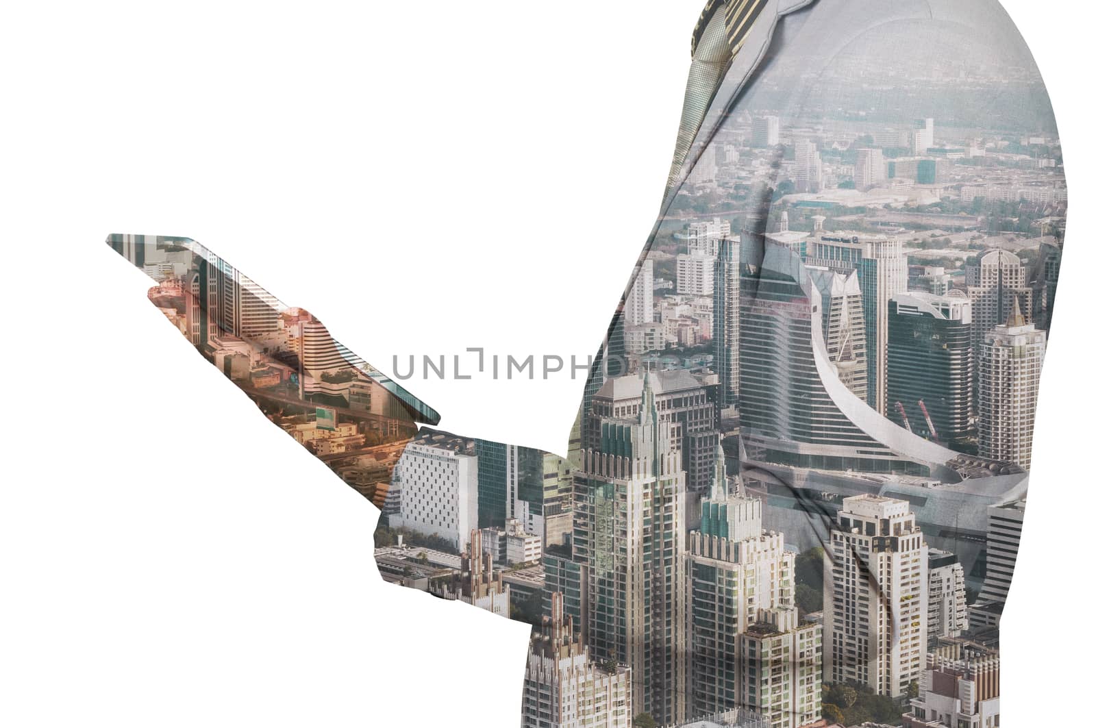 Double exposure of a businessman and a city using a tablet over white background
