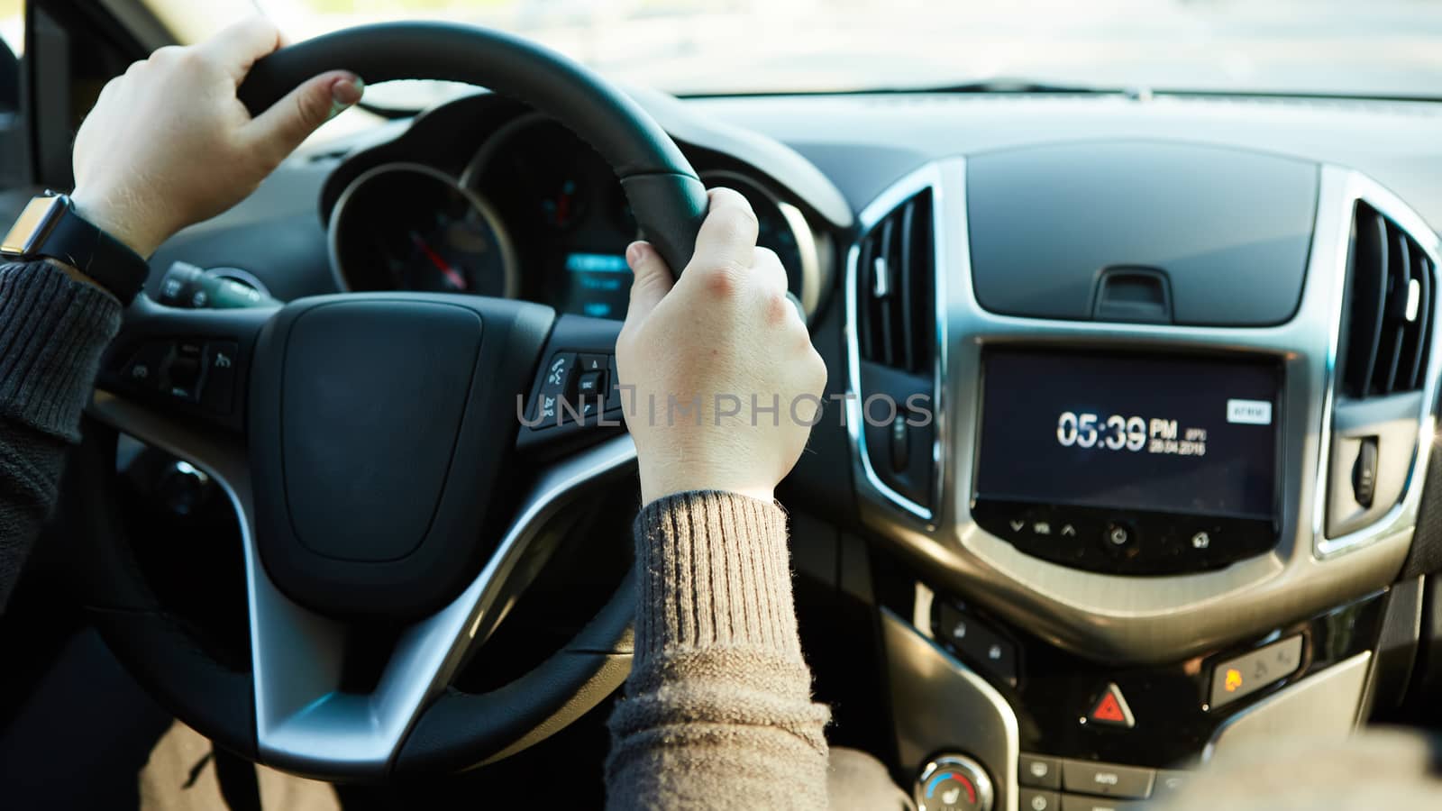 Closeup Of A Man Hands Holding Steering Wheel While Driving Car with retro filter effect