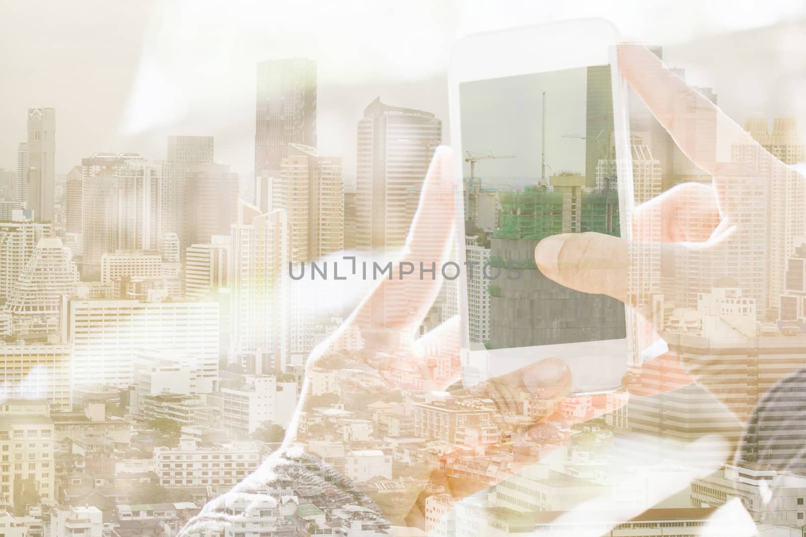 Double exposure of cityscape and smart phone, communication technology concept.