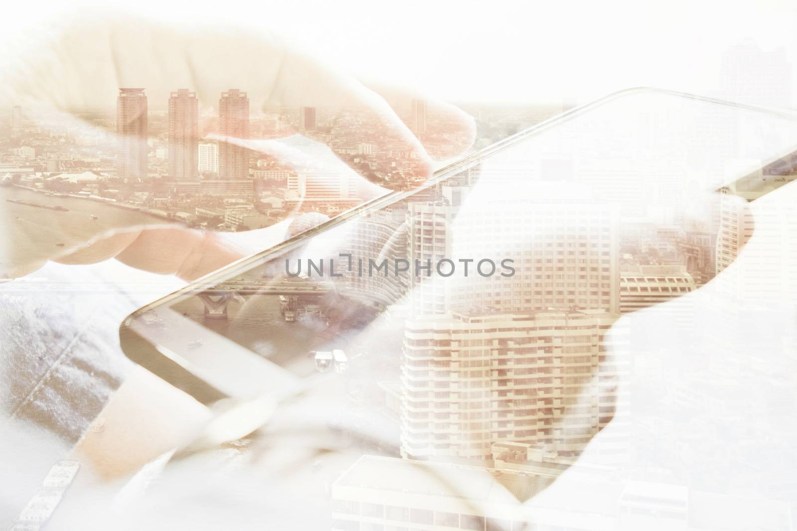 Double exposure of cityscape and smart phone, communication technology concept.