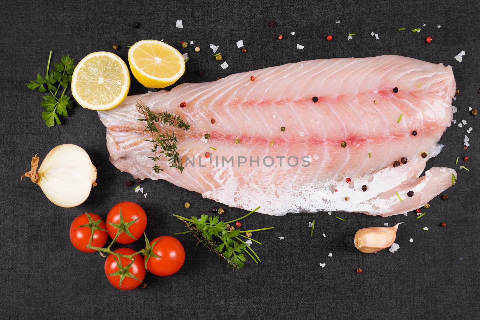 Luxurious perch fillet on black background, top view. Culinary fish eating. 