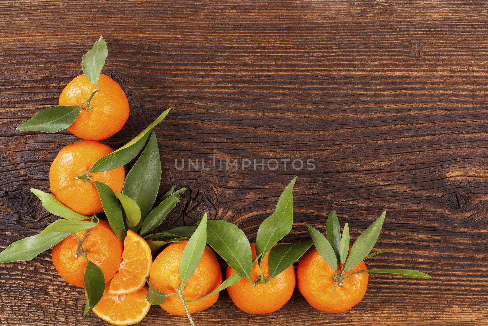 Fresh ripe mandarines on wooden table. by eskymaks