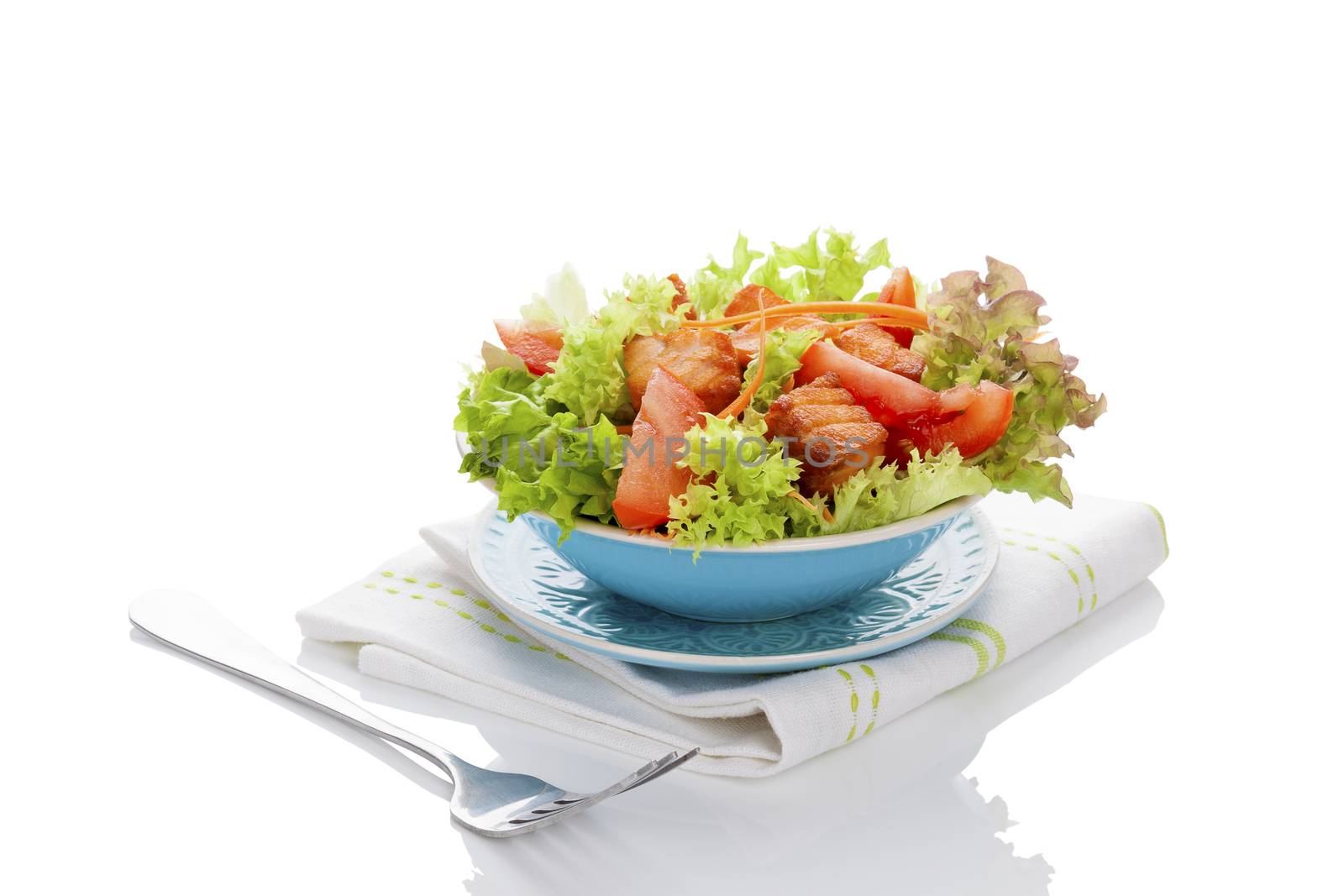 Fresh vegetable salad with roasted salmon pieces. Delicious healthy salad eating. 