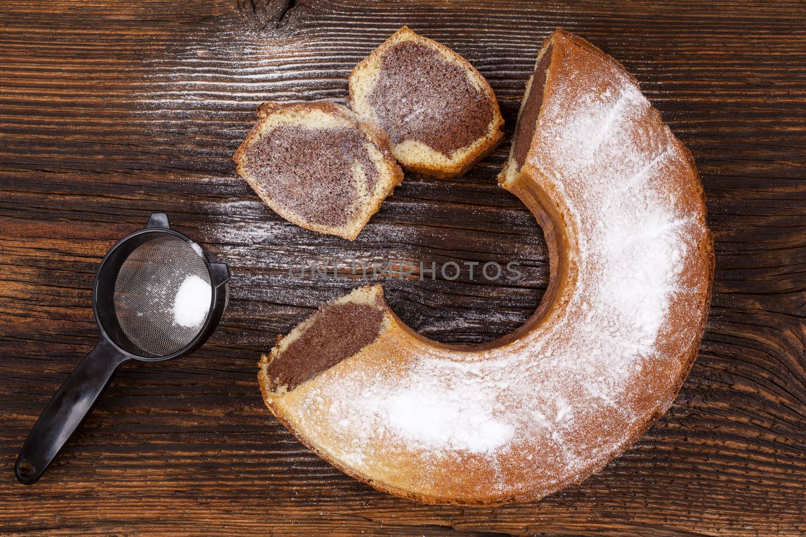 Delicious bundt cake on wooden table, top view. Traditional european sweet bundt cake.