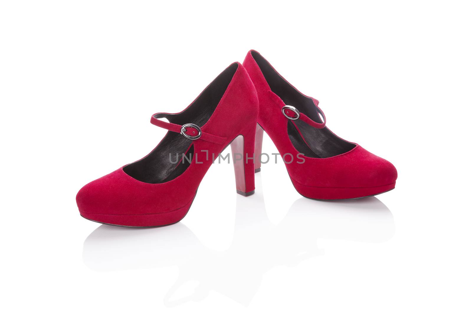 Red high heels isolated on white background with reflection. Classic woman shoe.
