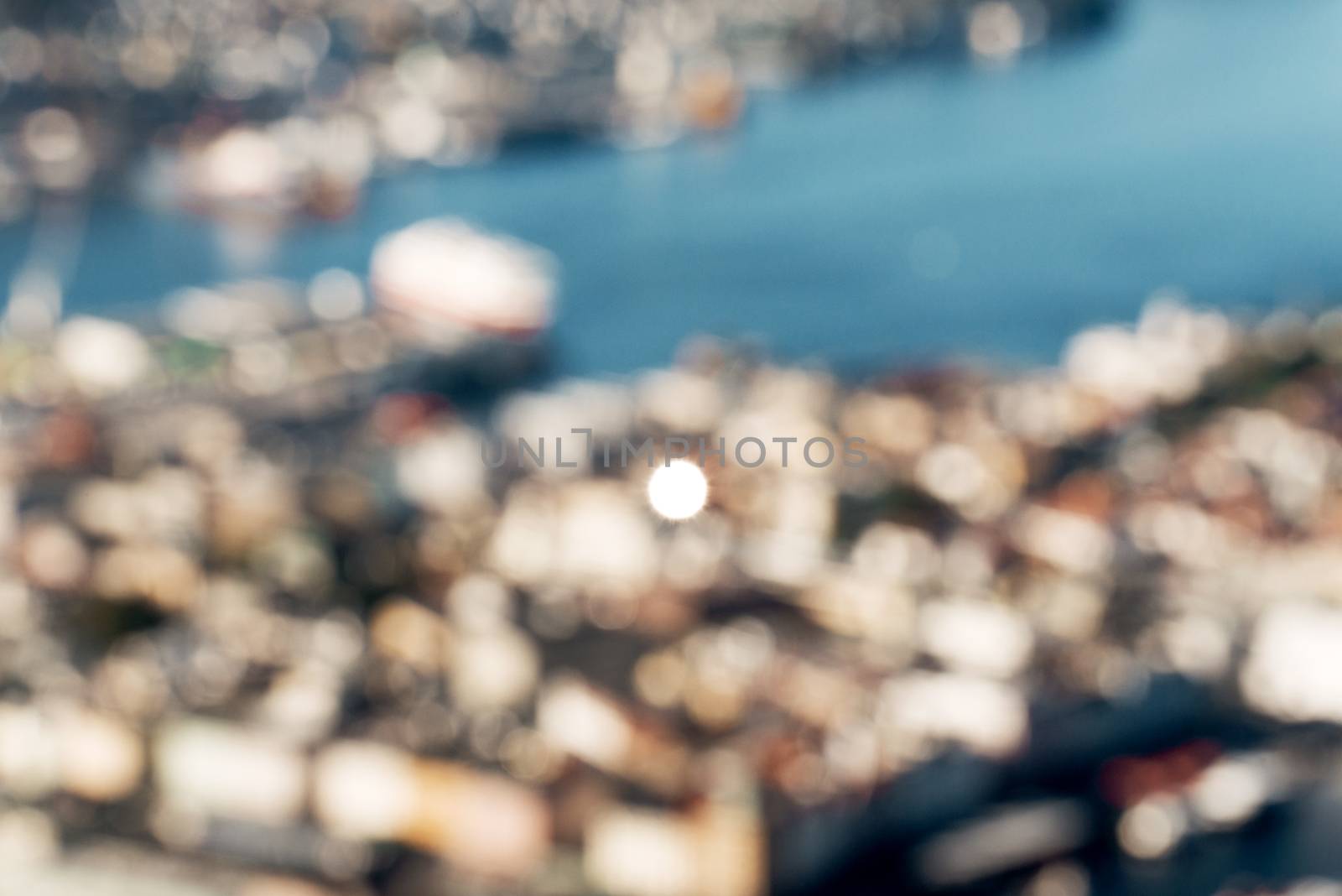 Defocused view of Bergen city with sun reflection in window by nejuras