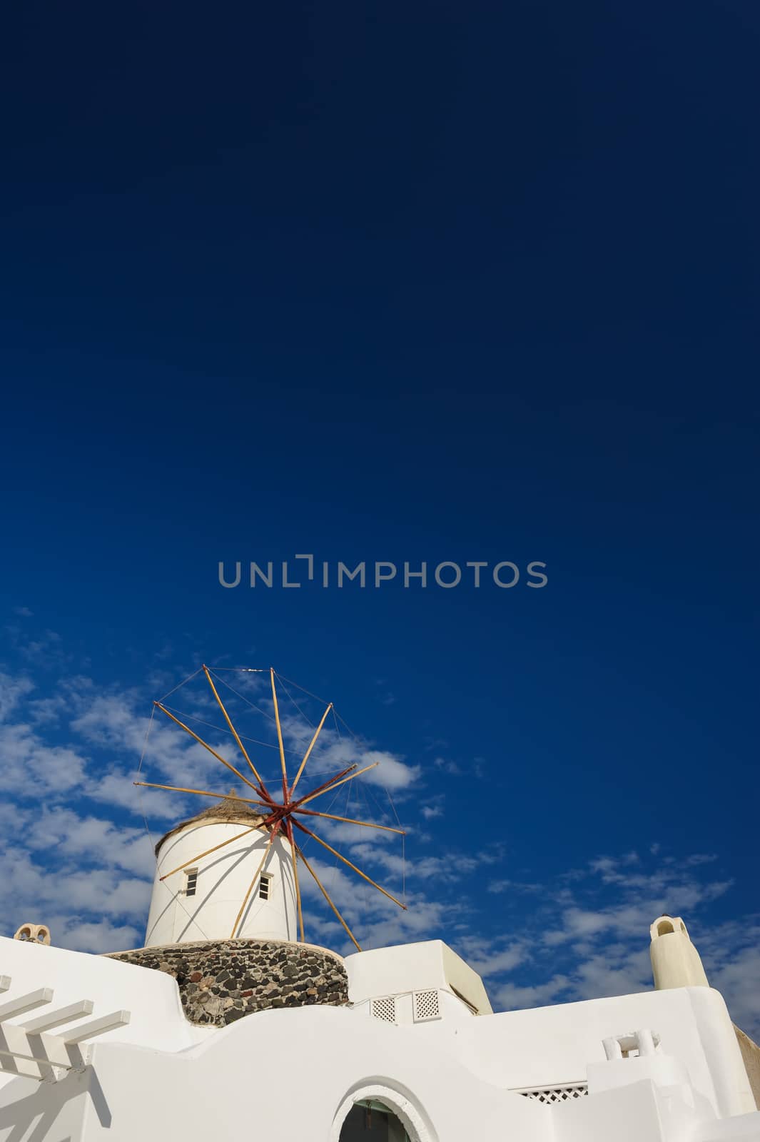 View of Oia windmill at the Island Santorini, Greece. Natural Gradient, lot of copyspace.