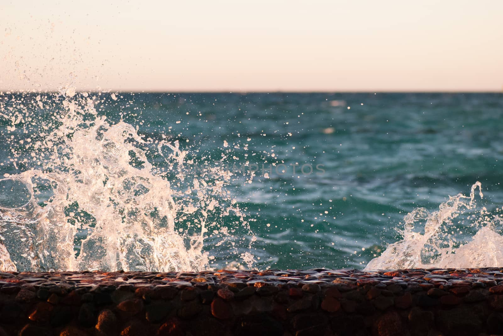 Photo closeup of beautiful clear turquoise sea ocean water surface with ripples and bright splash on seascape background, horizontal picture.