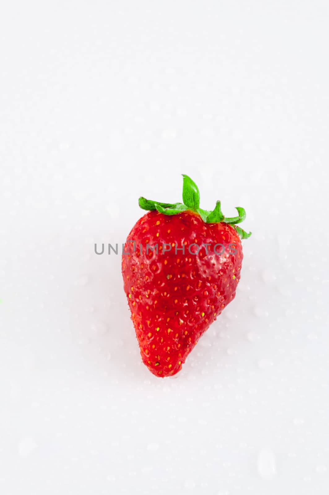 Closeup of strawberry with dew drops on white background