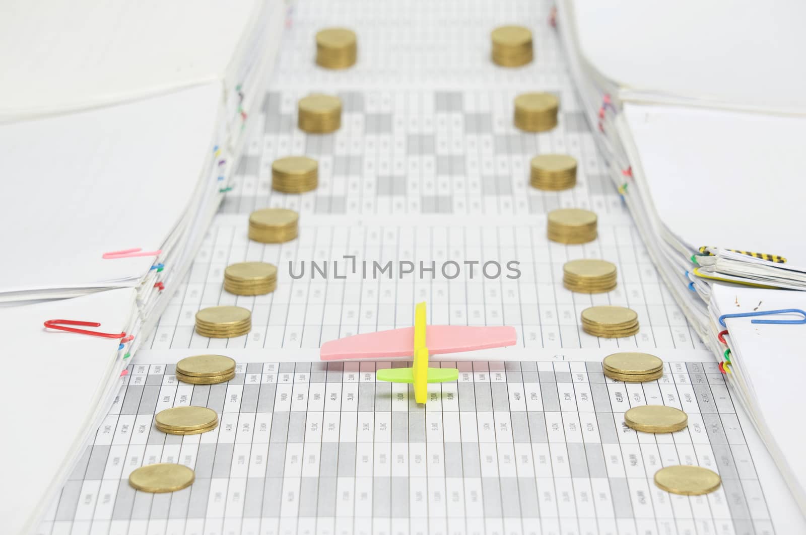 Yellow airplane between step pile of gold coins and paperwork by eaglesky