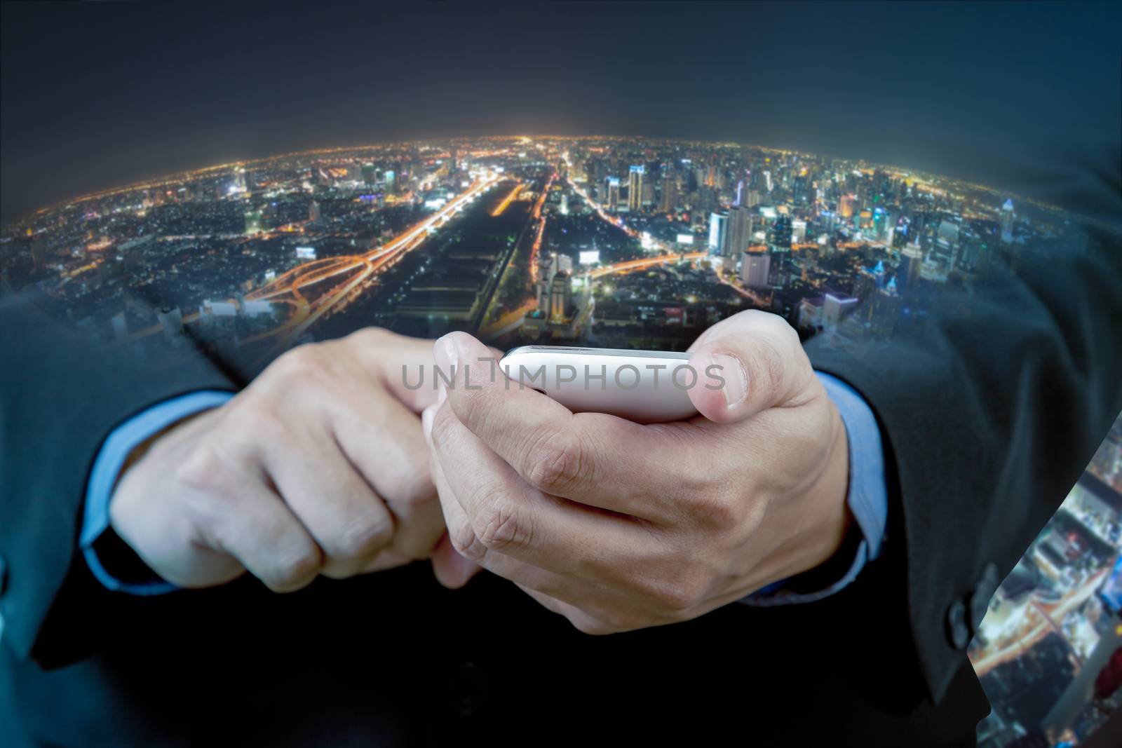 Businessman touch smart phone in hand with blur background of ci by FrameAngel