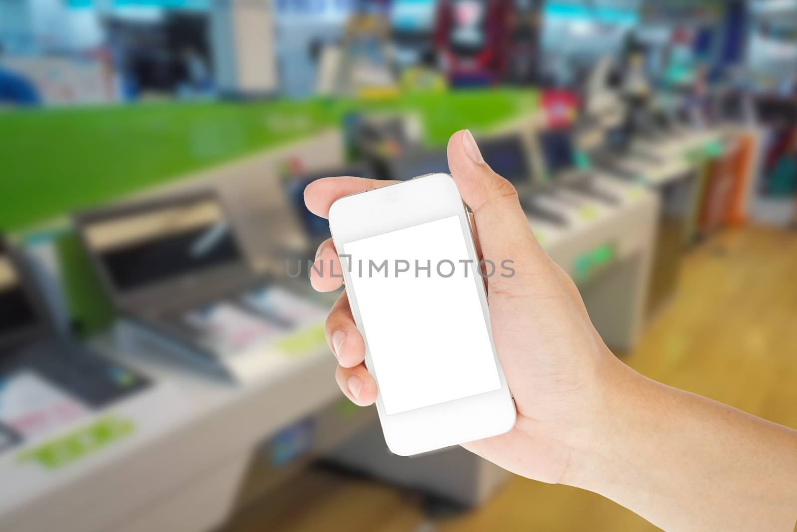 Hand holding smart phone with blur background of shopping IT mall market