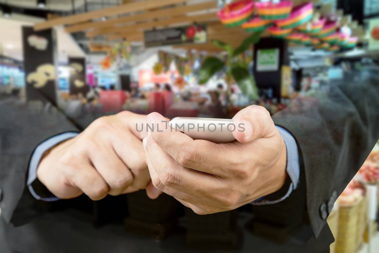 Businessman touch smart phone in hand with blur background of sh by FrameAngel