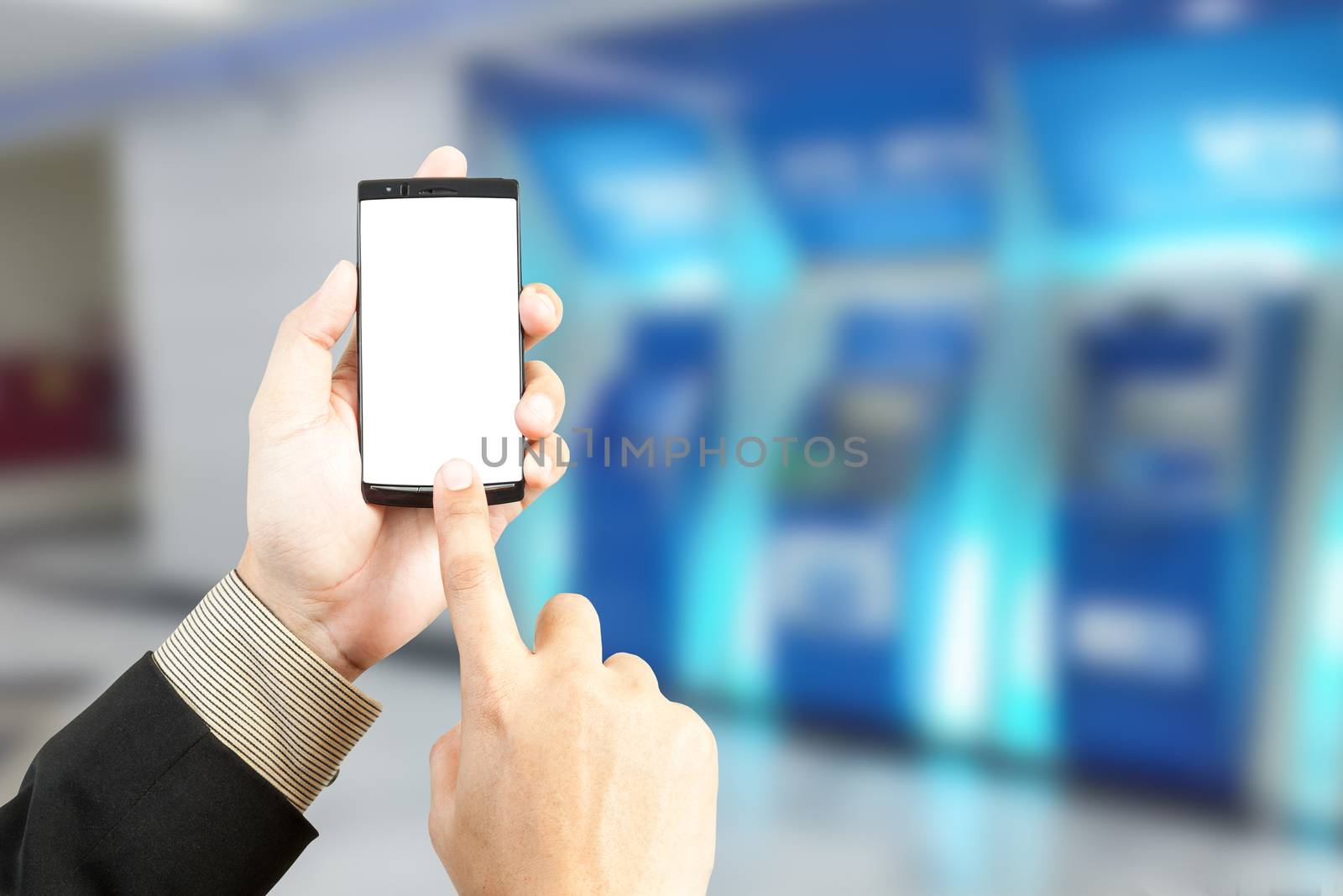 Hand holding smartphone for transfer banking with blur background of money machine, business financial or shopping concept