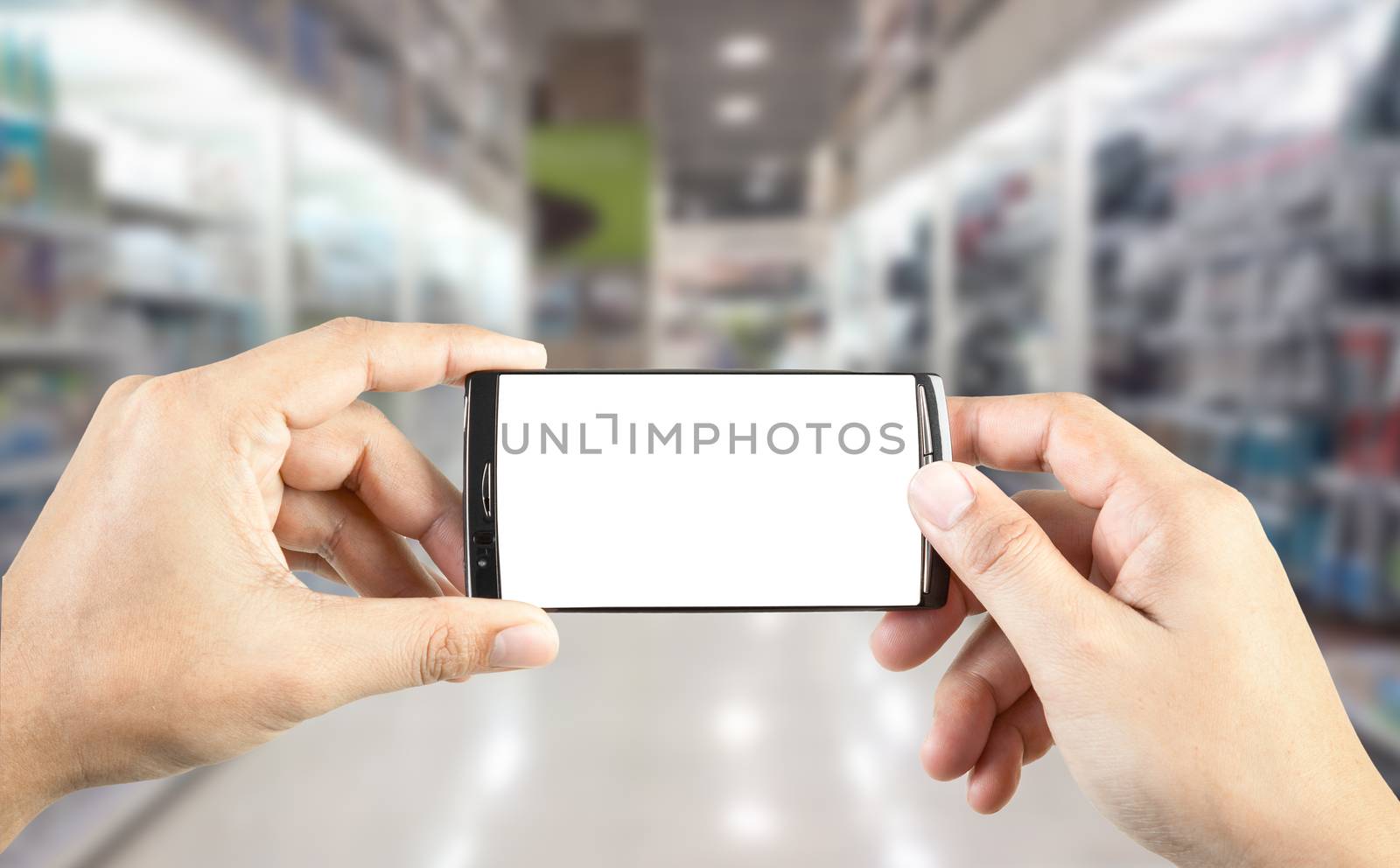 Hand holding smart phone with blur background of shopping mall market, business financial or shopping concept