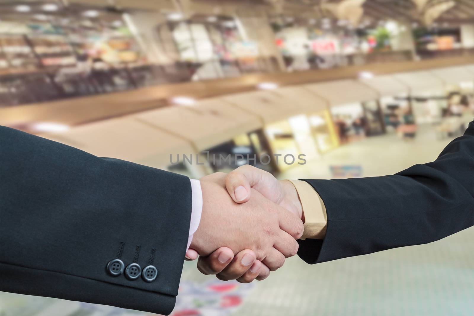 Business handshake with blur background of shopping mall market