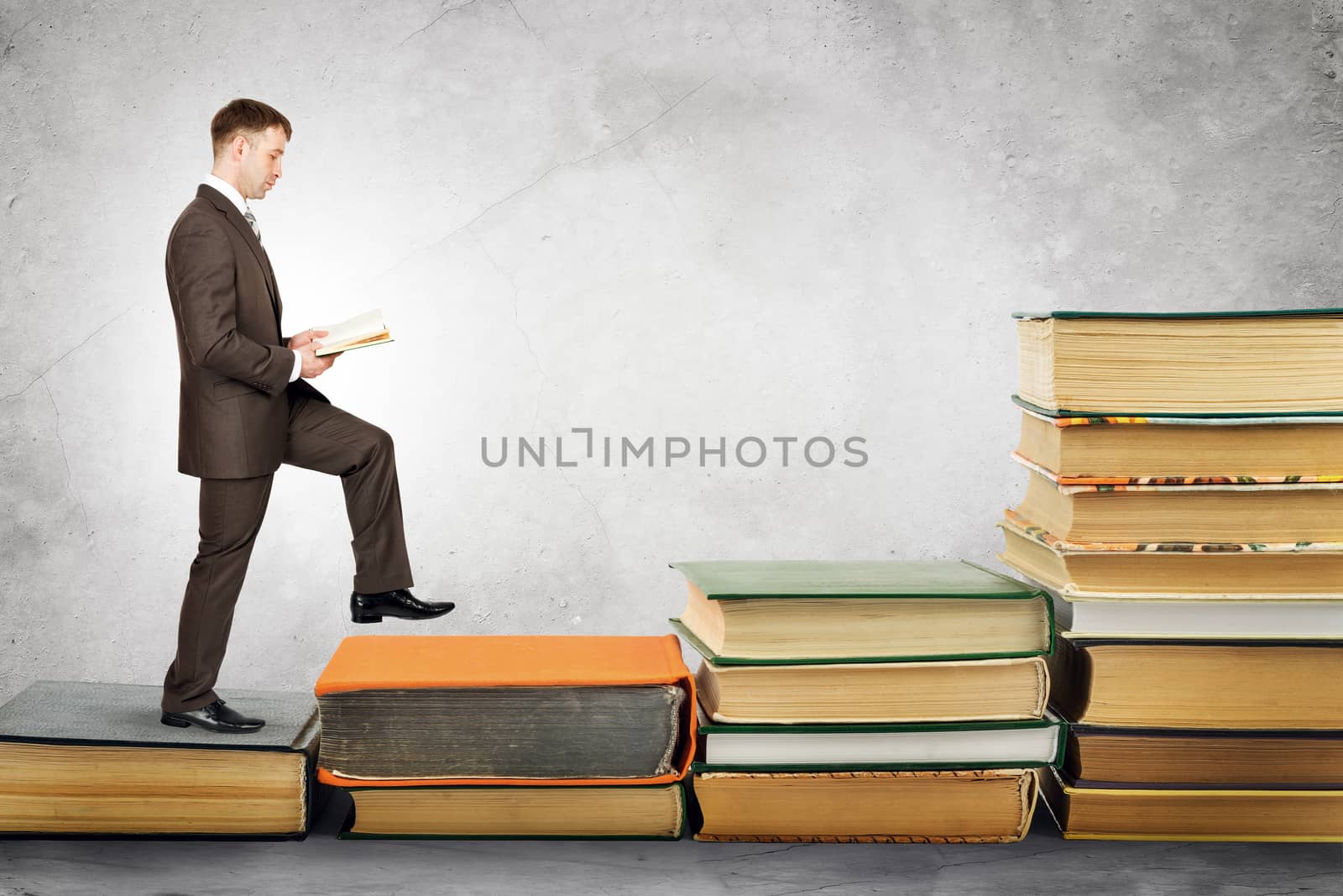 Businessman reading book and walks up by cherezoff