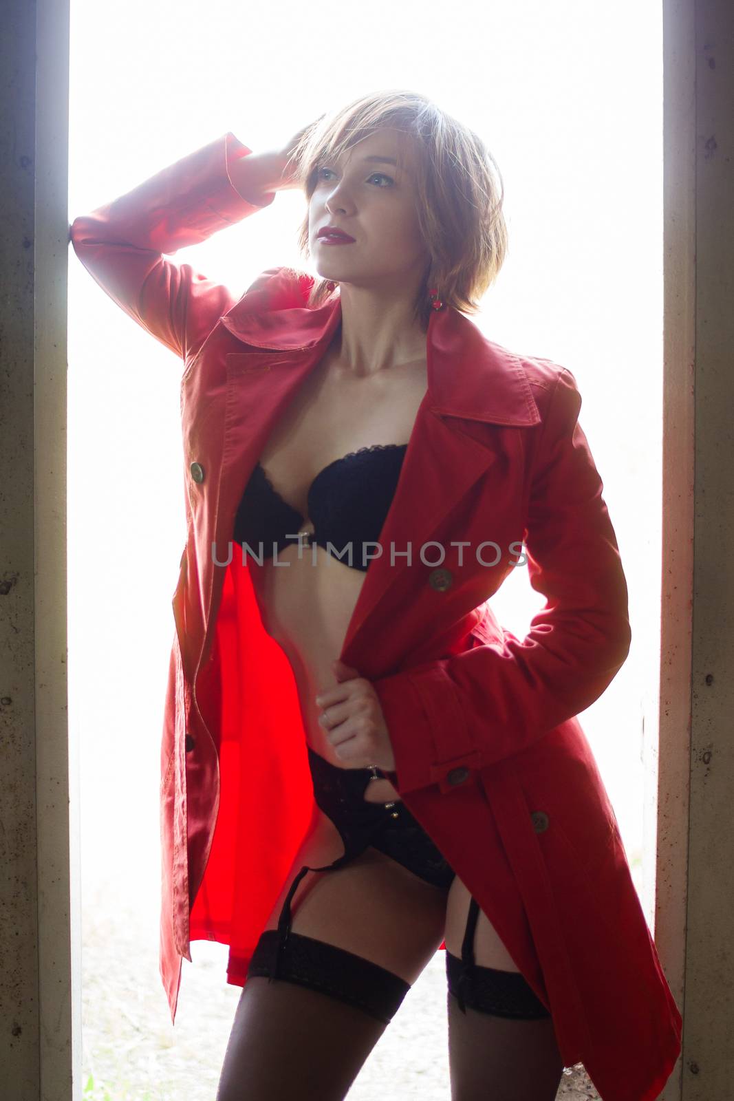 Attractive woman alluring in lingerie and coat. by mrakor