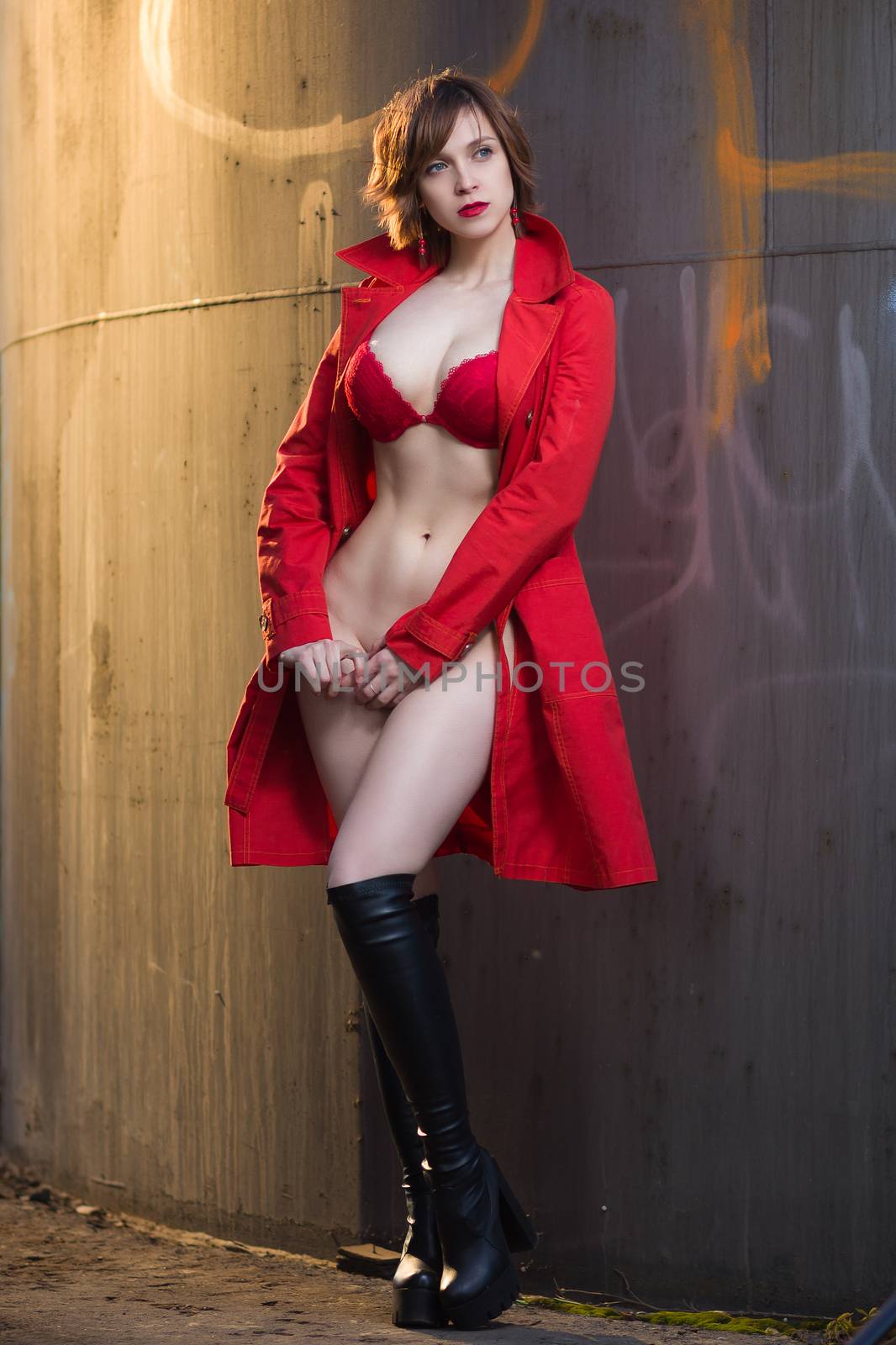 Attractive woman alluring in lingerie and coat. by mrakor