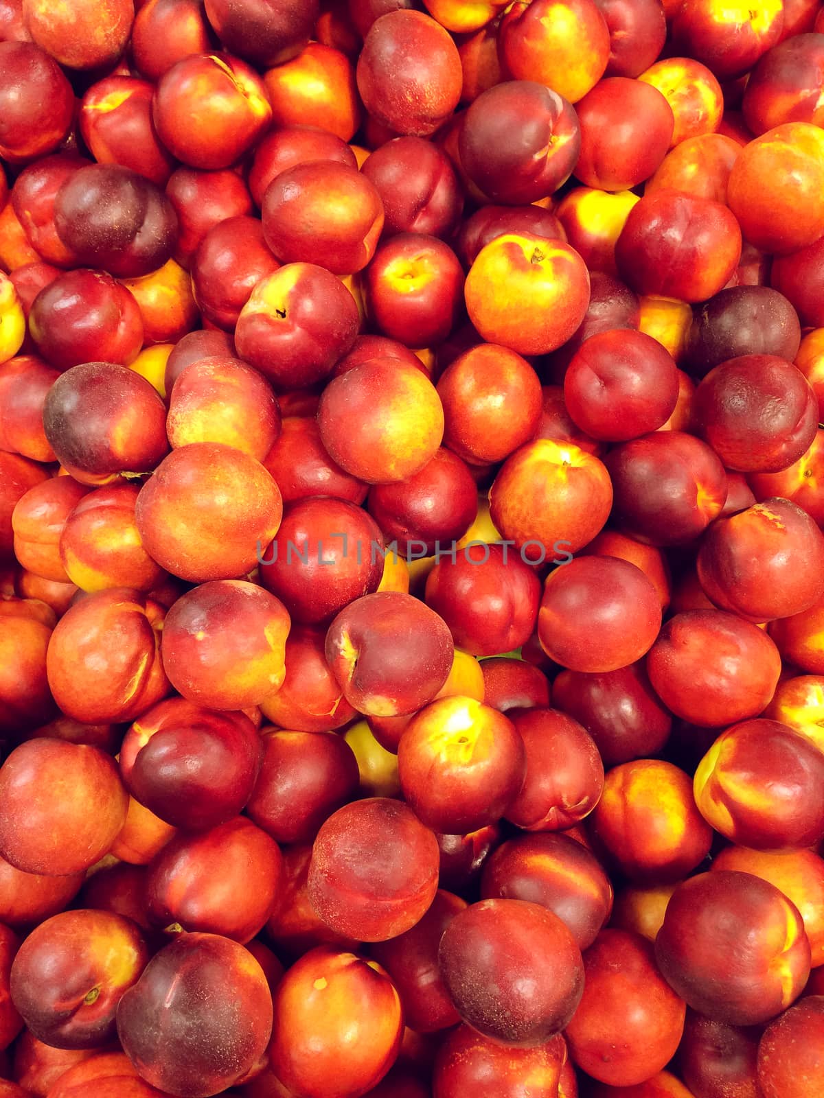 Sweet red peaches at the market. Fruit background.