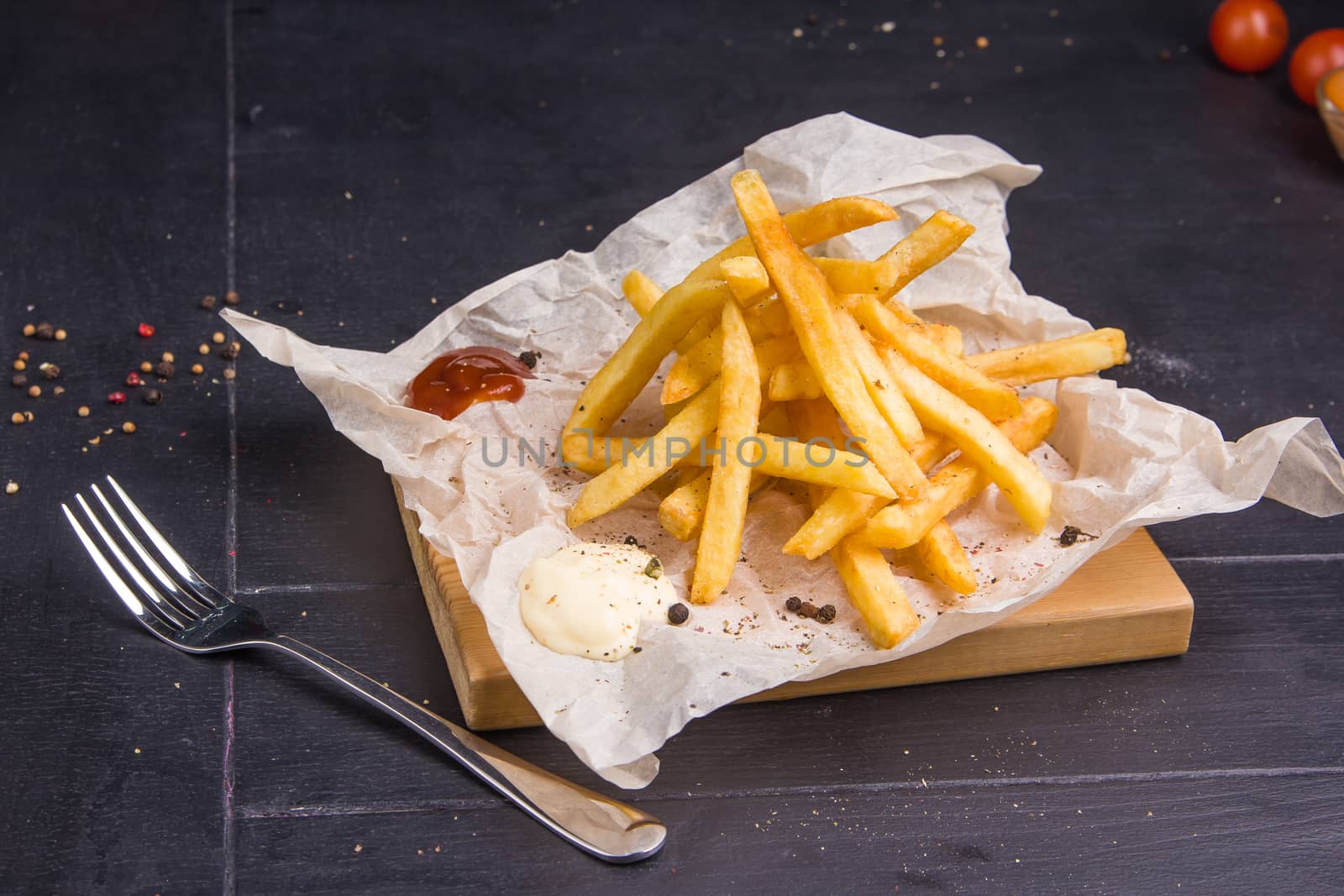 Homemade fries on a table with ingredients and cutlery around. Concept: healthy food, diet, fastfood. 