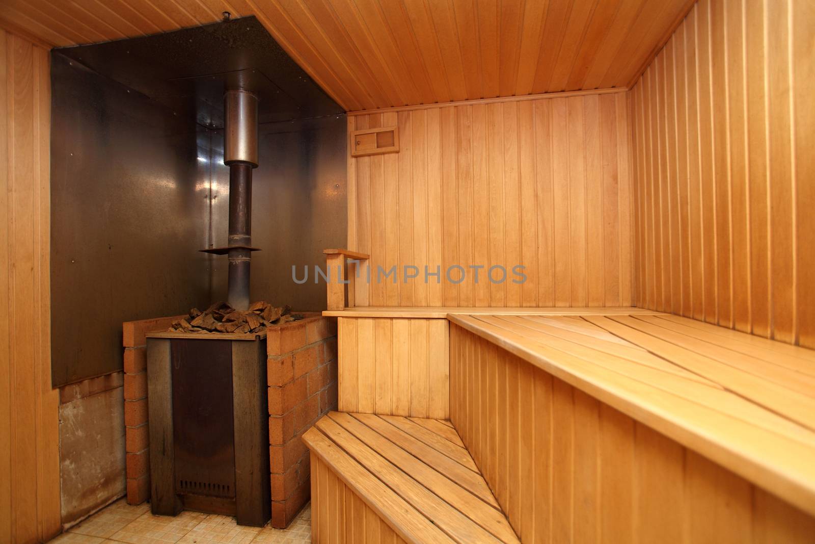 sauna with the furnace with wooden walls