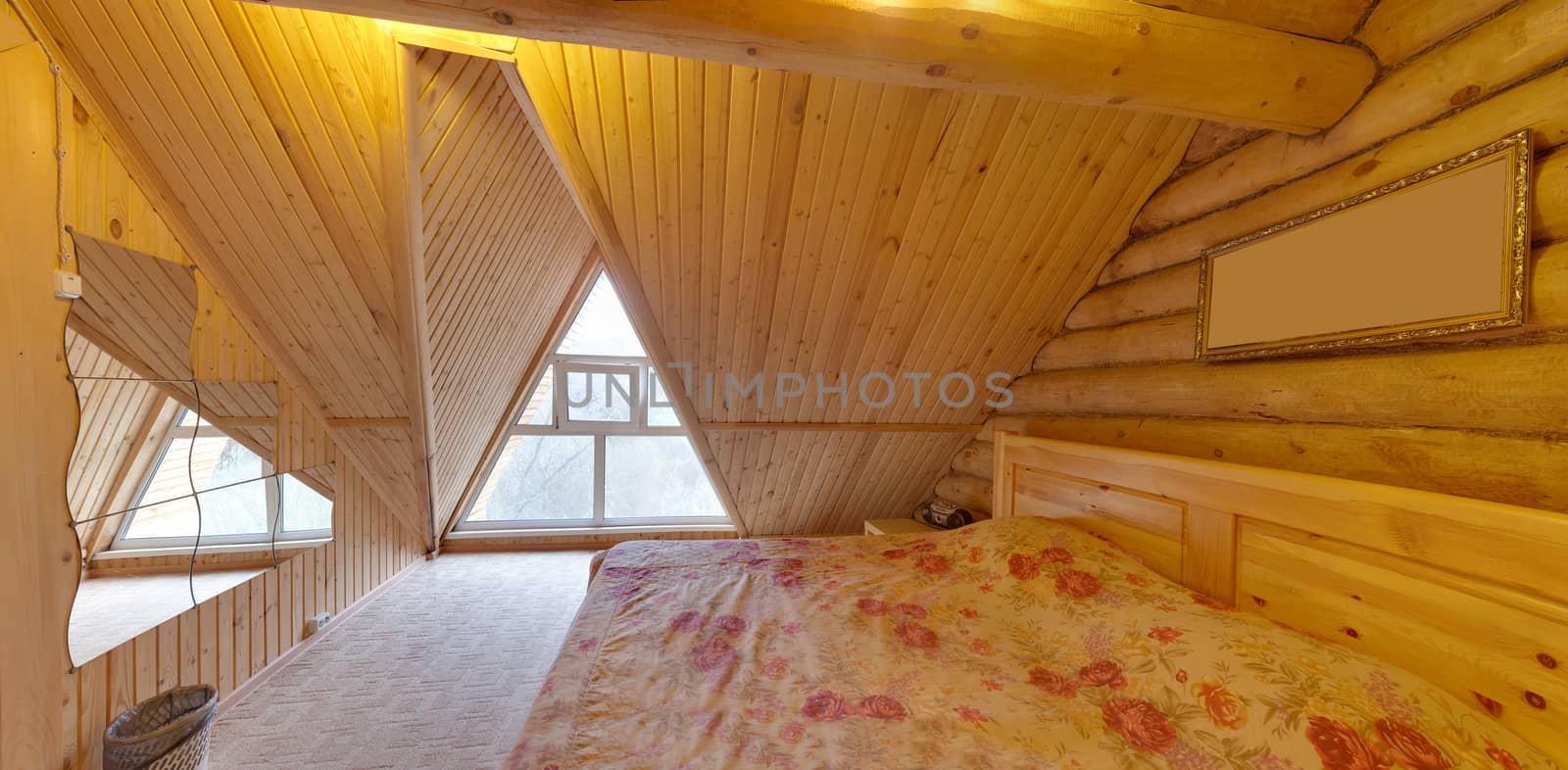 bedroom with a big bed in the house with wooden walls