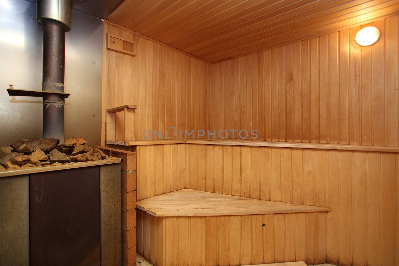 sauna with the furnace with wooden walls