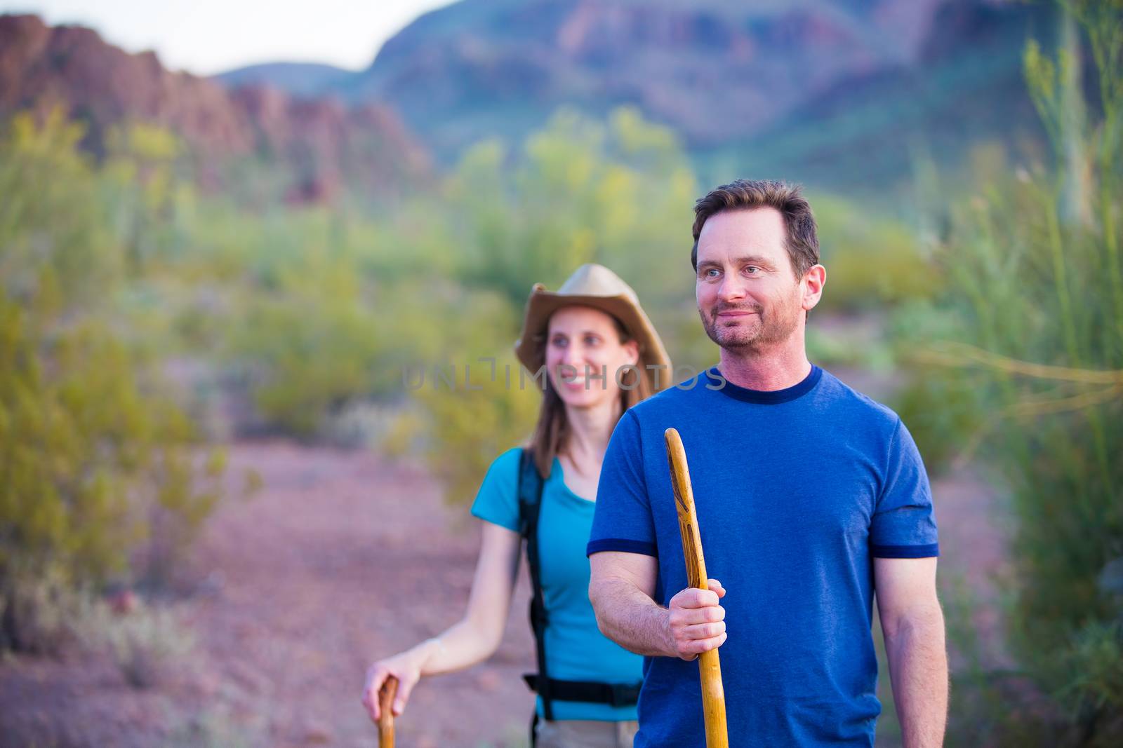 Couple desert hiking near mountains in the American Southwest