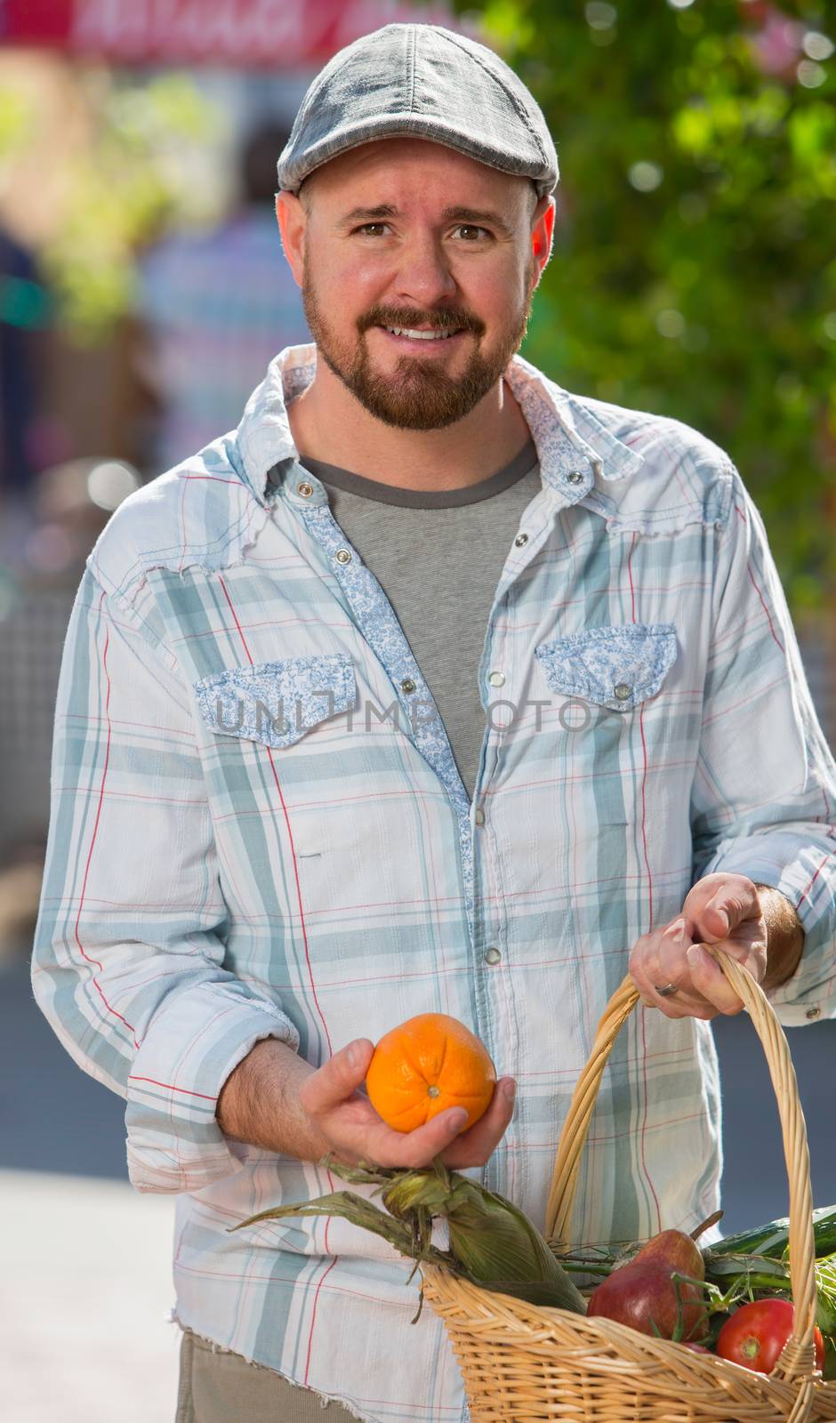 Man with basket of produce at farmers market