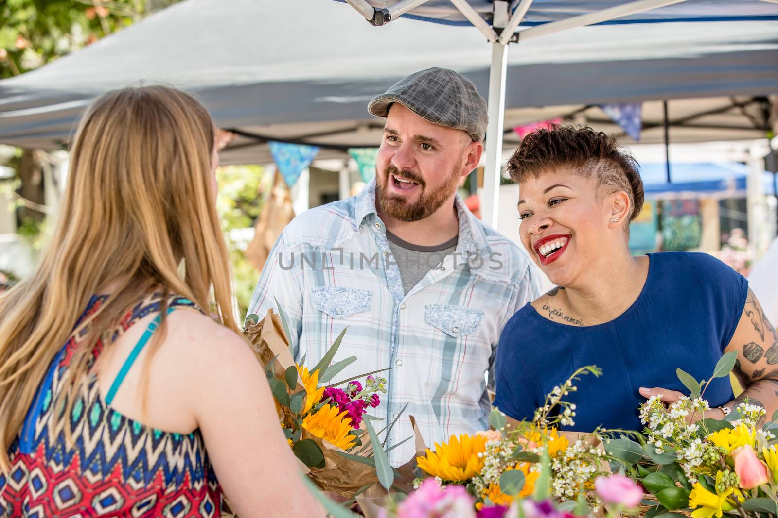 Attractive couple shopping for flowers at outdoor farmers market