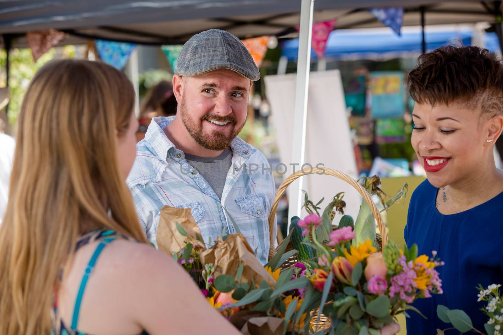 Couple shopping for flowers at outdoor farmers market