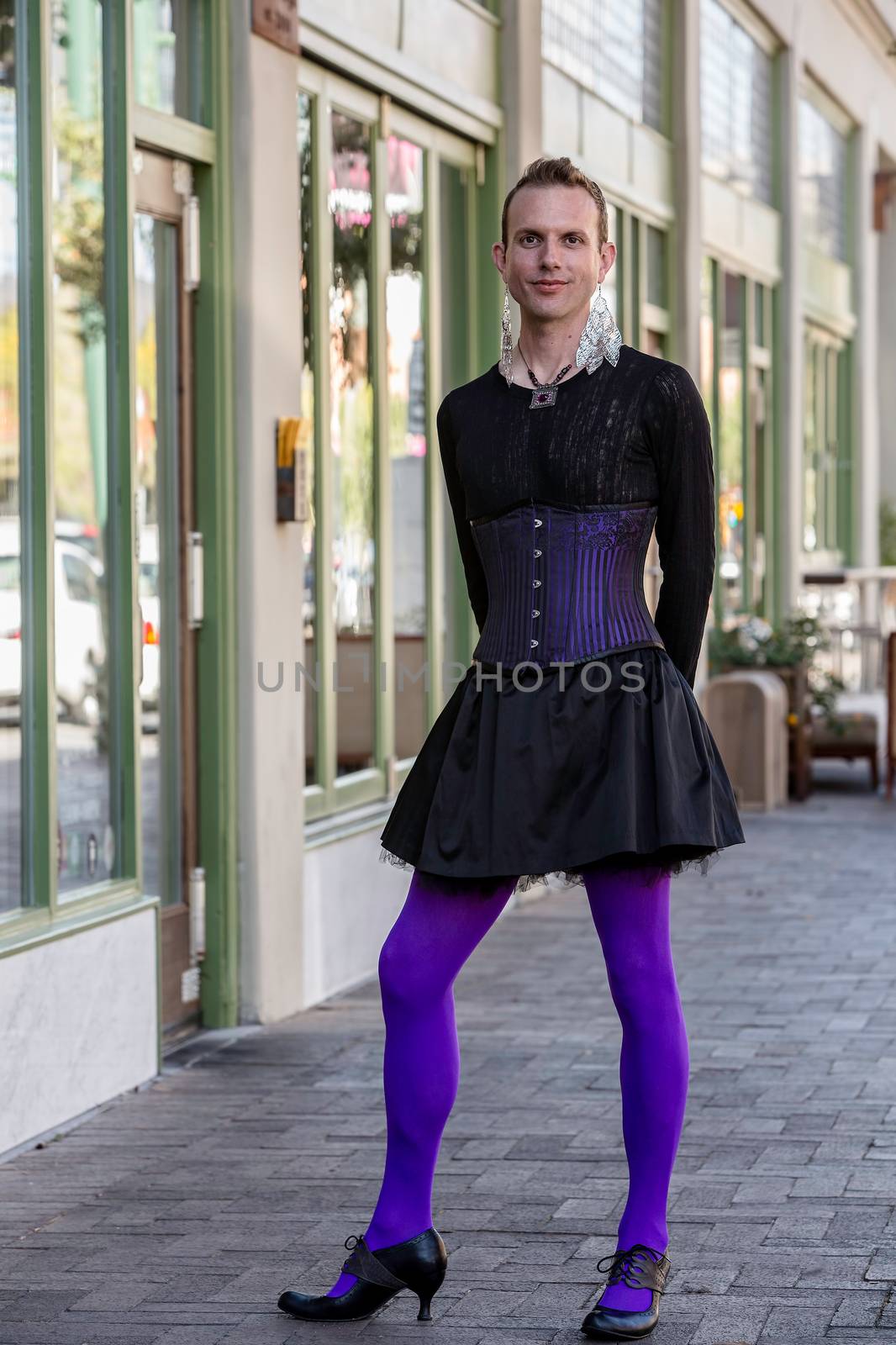 Gender fluid young man in corset and high heels