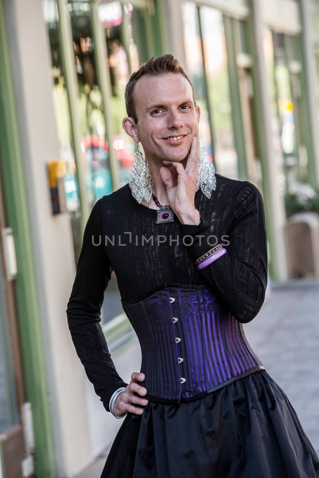 Gender fluid young man in corset and skirt