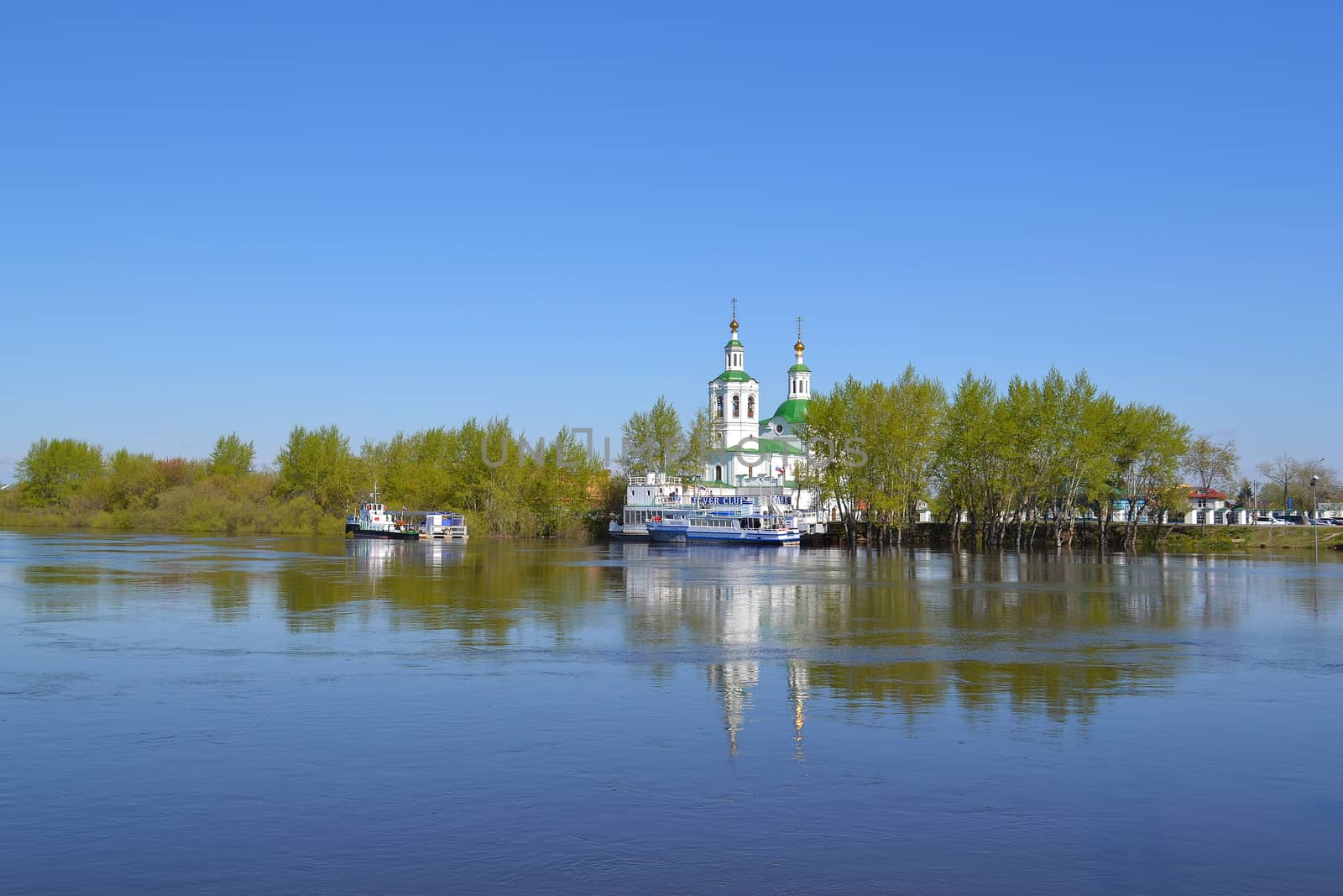 Voznesensko-Church of St. George and boats at the mooring on the Tura River in Tyumen, Russia. May, 2016