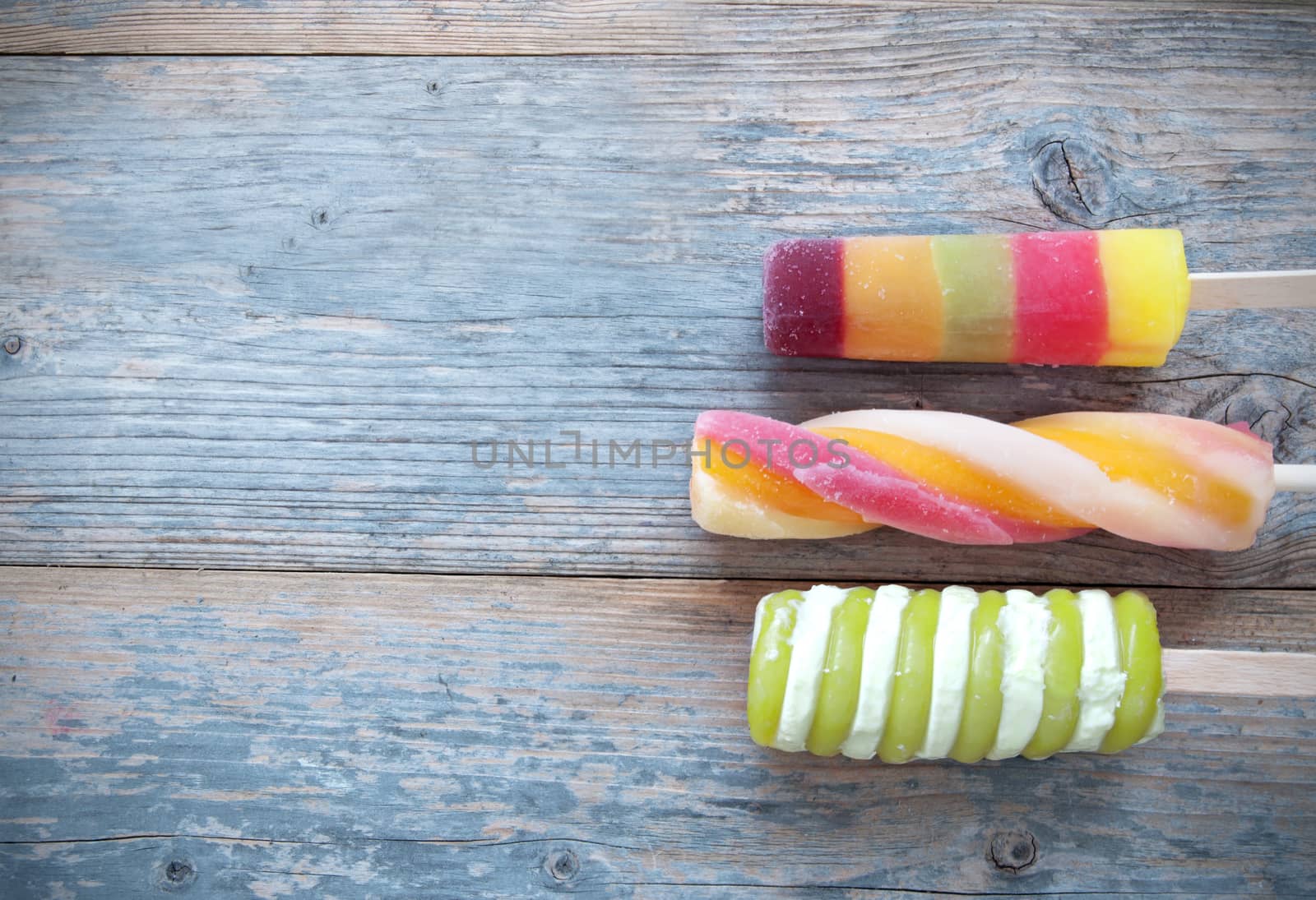 Frozen ice lollies on a wooden background