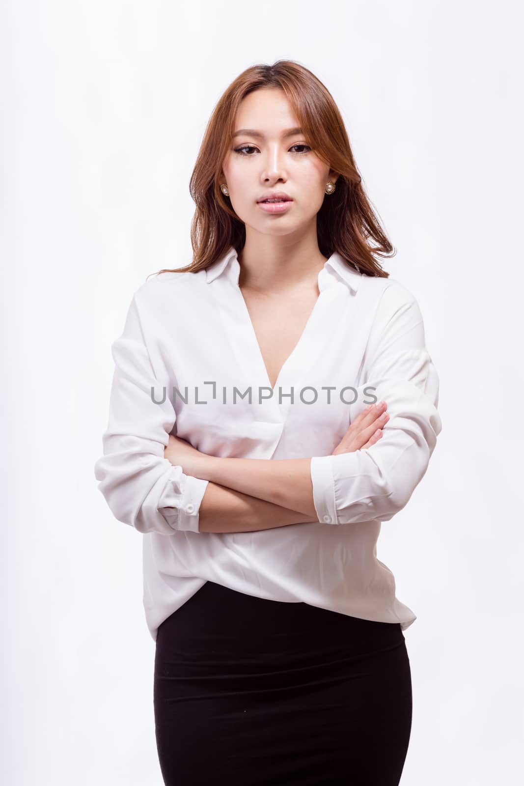 Asian American businesswoman with crossed arms looking at camera